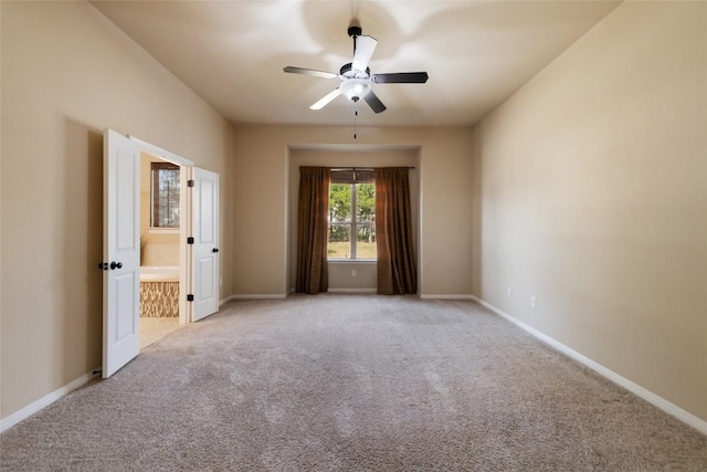 spare room with light carpet, baseboards, and a ceiling fan