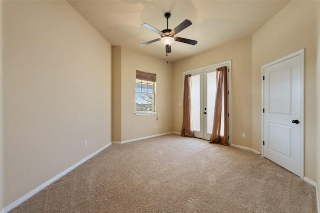 unfurnished bedroom featuring light carpet, baseboards, a ceiling fan, access to outside, and french doors