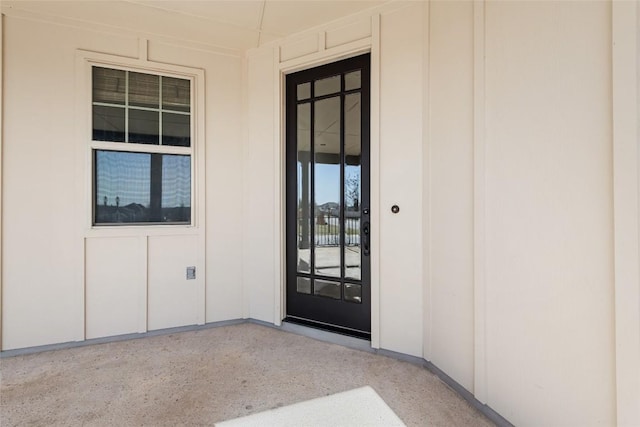 entrance to property featuring board and batten siding