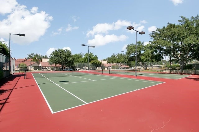 view of tennis court with fence and community basketball court