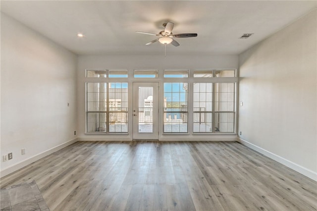 spare room with baseboards, a ceiling fan, wood finished floors, and recessed lighting