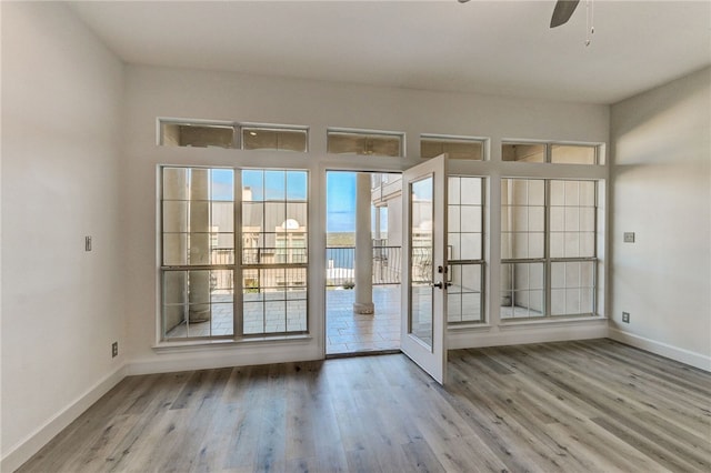 entryway with french doors, wood finished floors, baseboards, and a ceiling fan