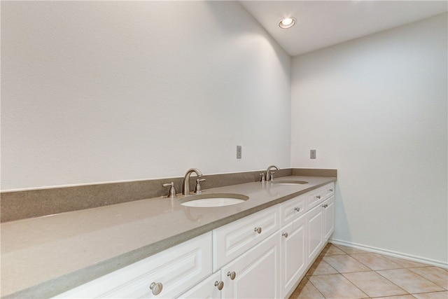 bathroom featuring tile patterned floors, double vanity, recessed lighting, and baseboards