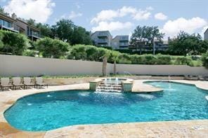 community pool with a community hot tub, a patio area, and fence