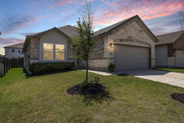 view of front of home featuring a yard, an attached garage, fence, and driveway