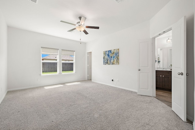 unfurnished room with ceiling fan, baseboards, and light colored carpet