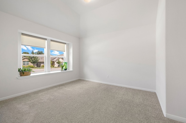 carpeted empty room with baseboards