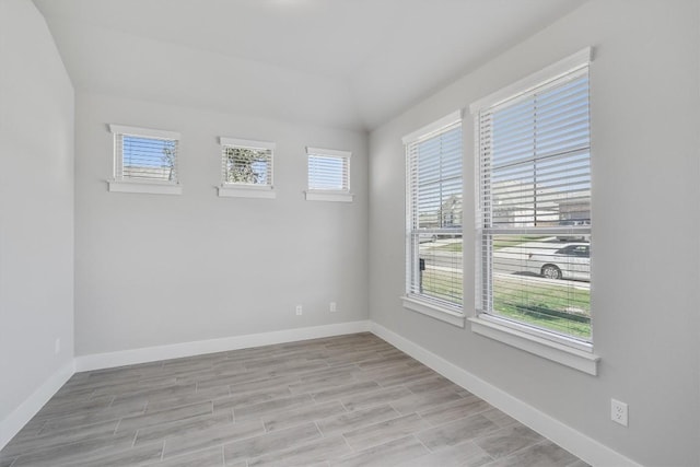 unfurnished room with light wood-style flooring and baseboards