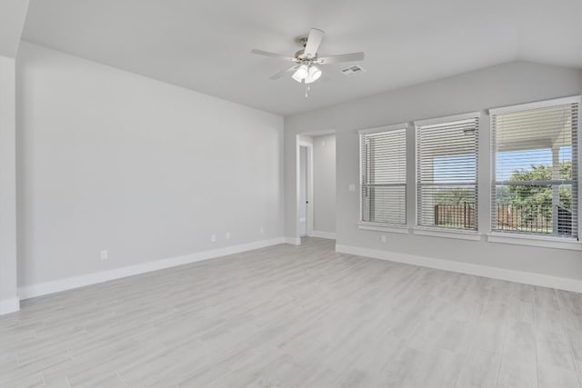 empty room with light wood-style floors, ceiling fan, visible vents, and baseboards