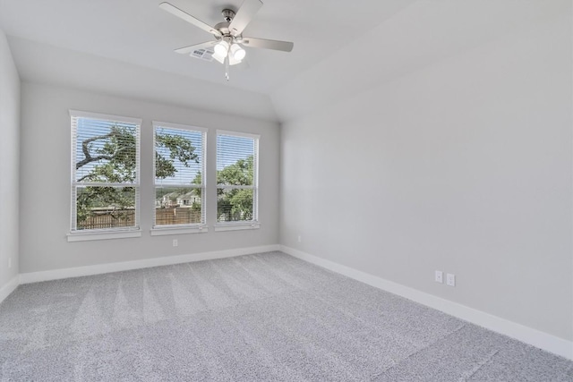 unfurnished room featuring lofted ceiling, a ceiling fan, baseboards, and carpet flooring