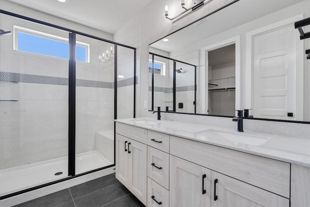 full bath featuring a stall shower, a healthy amount of sunlight, and a sink