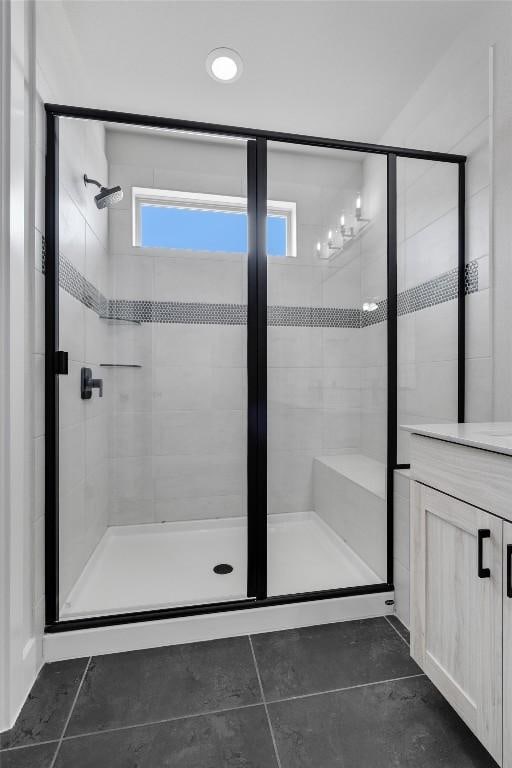 bathroom with a stall shower and tile patterned floors