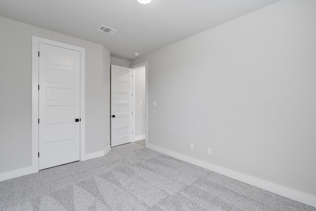 unfurnished bedroom featuring baseboards, visible vents, and carpet flooring