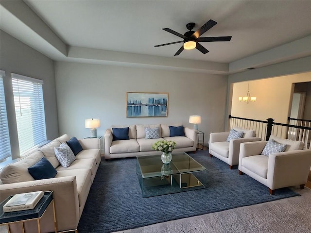 living room with visible vents, carpet flooring, and ceiling fan with notable chandelier