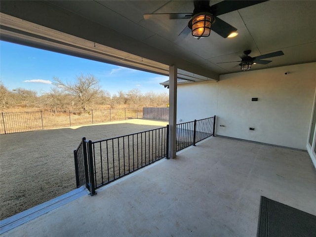 view of patio featuring fence and a ceiling fan