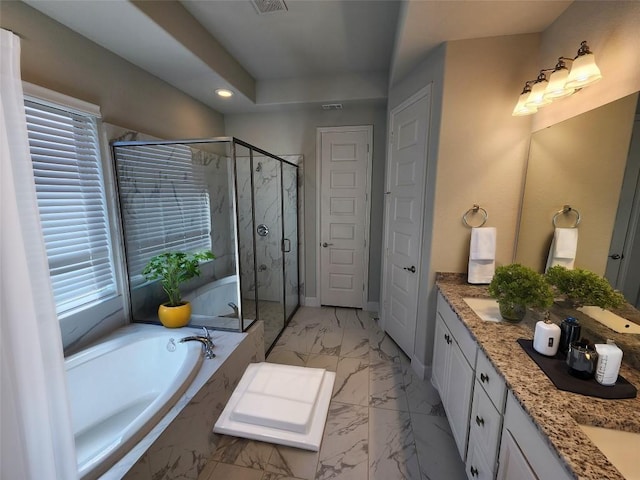 bathroom with marble finish floor, a garden tub, a marble finish shower, double vanity, and baseboards