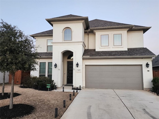 view of front of home with a garage, fence, driveway, and stucco siding