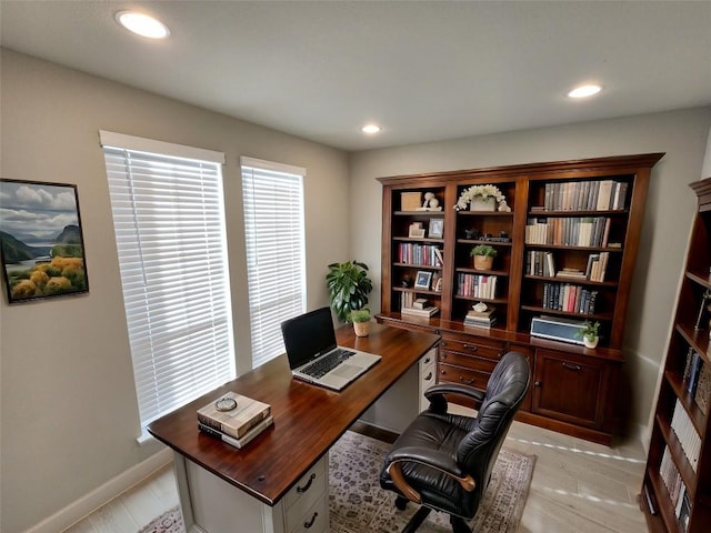 home office featuring baseboards, light wood-type flooring, and recessed lighting