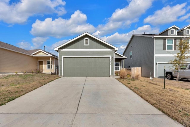 view of front of house featuring a front lawn, driveway, and an attached garage