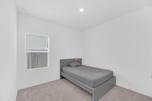 bedroom featuring carpet floors and baseboards