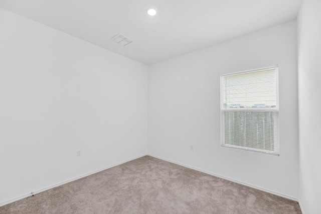 unfurnished room with baseboards, visible vents, carpet flooring, and recessed lighting