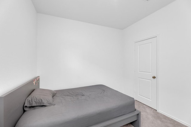 bedroom featuring light carpet