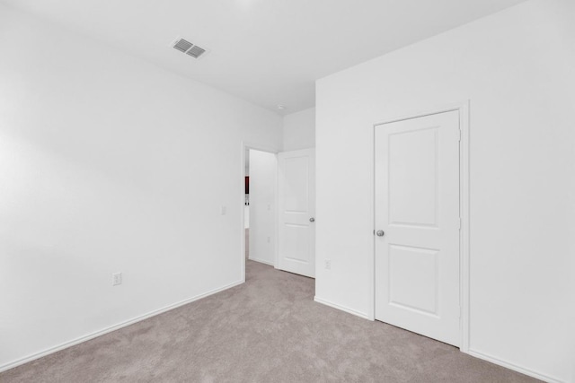 unfurnished bedroom featuring carpet floors, baseboards, and visible vents