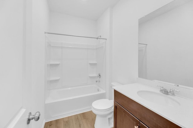 bathroom with shower / bathing tub combination, vanity, toilet, and wood finished floors