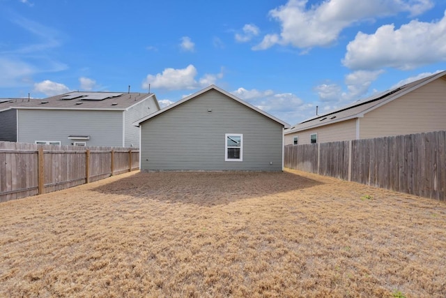 rear view of property with a fenced backyard