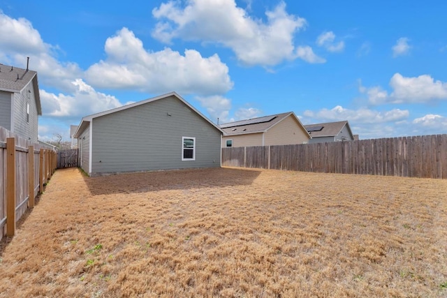 rear view of property with a fenced backyard