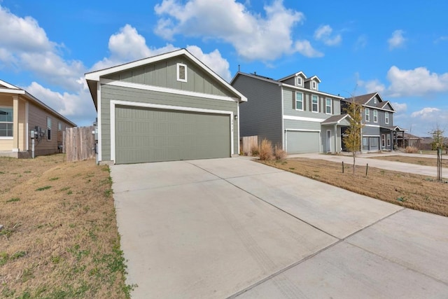 view of front of home featuring board and batten siding, driveway, and fence