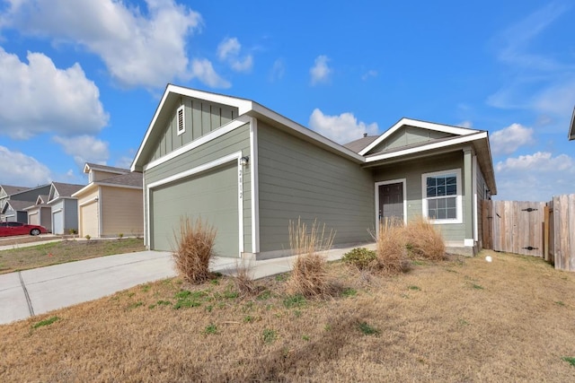 single story home with driveway, board and batten siding, an attached garage, and fence