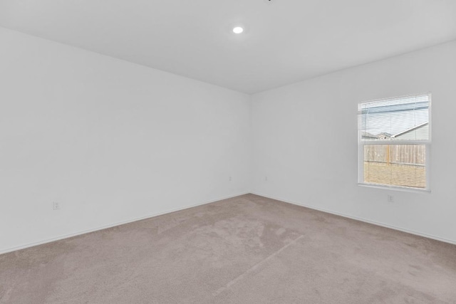 carpeted empty room with recessed lighting