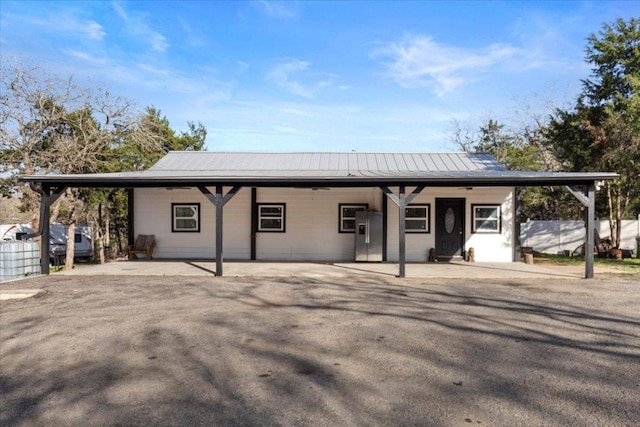 view of front of house featuring fence and metal roof