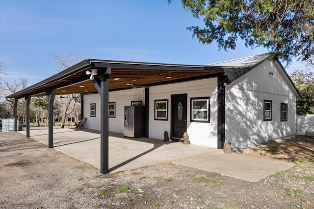 240 Riddle Rd, Cedar Creek, TX 78612 - back of property featuring a carport and metal roof