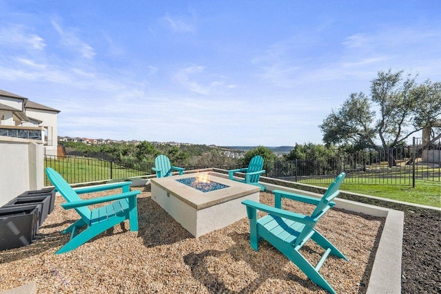 view of community featuring an outdoor fire pit and fence