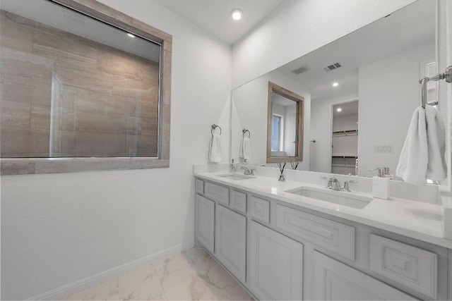 full bathroom featuring marble finish floor, a sink, visible vents, and baseboards