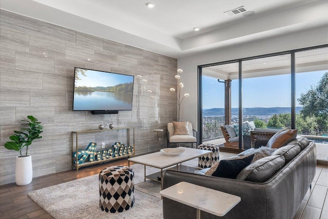 living room featuring visible vents and wood finished floors