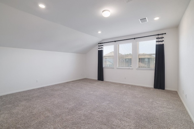 bonus room with baseboards, visible vents, light colored carpet, vaulted ceiling, and recessed lighting