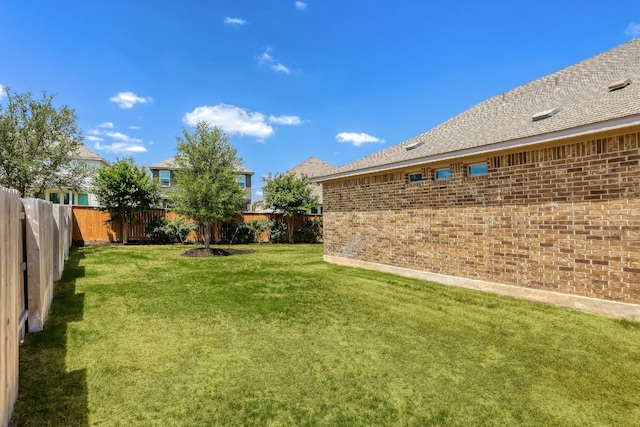 view of yard with a fenced backyard