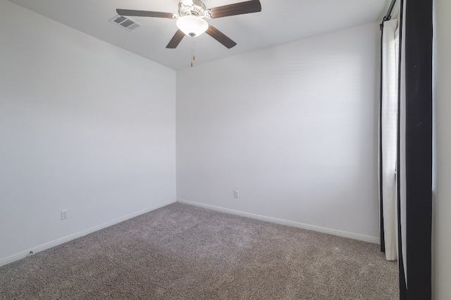 empty room with light carpet, ceiling fan, visible vents, and baseboards