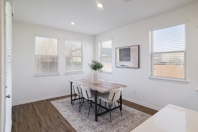 dining space with recessed lighting, dark wood-style flooring, and baseboards