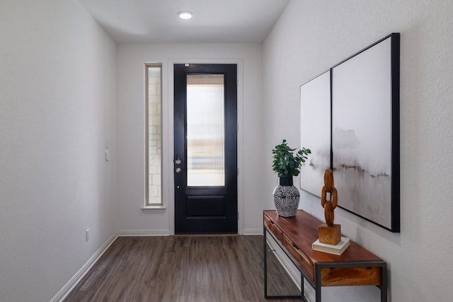 entryway featuring dark wood-style flooring and baseboards