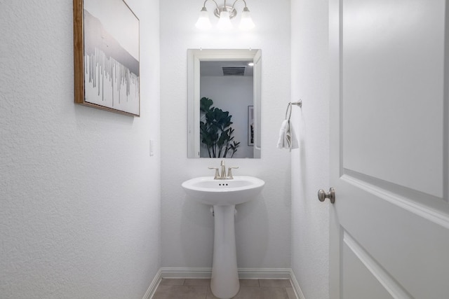 bathroom featuring tile patterned flooring, visible vents, and baseboards