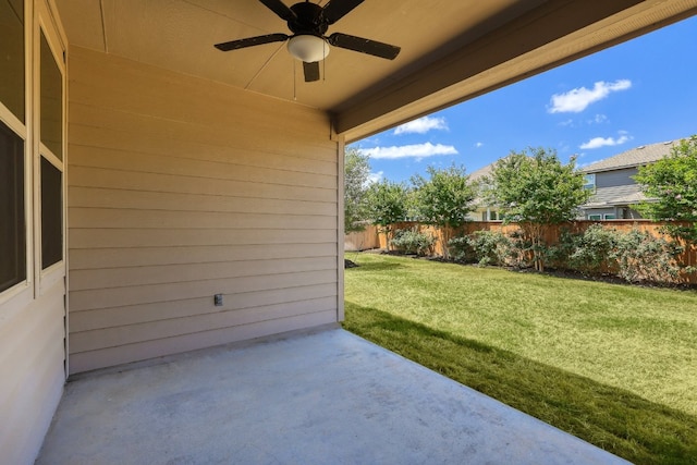 view of patio featuring a ceiling fan and fence