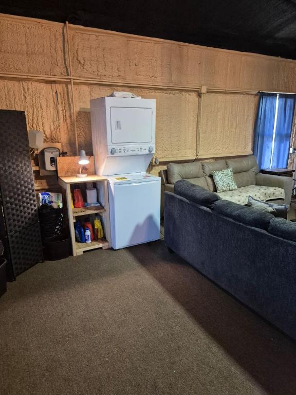 interior space featuring stacked washer / drying machine, carpet flooring, and laundry area