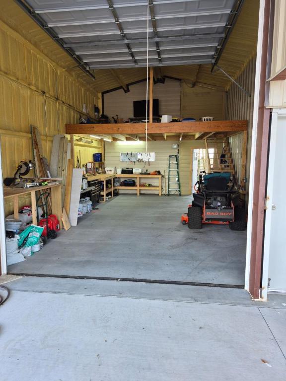 garage featuring a workshop area and metal wall