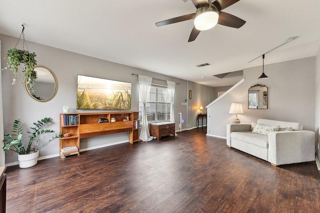 sitting room with a ceiling fan, visible vents, baseboards, and wood finished floors