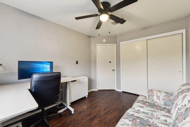 home office with ceiling fan, visible vents, baseboards, and wood finished floors