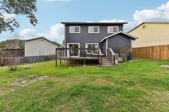 back of house with a deck, a yard, and a fenced backyard